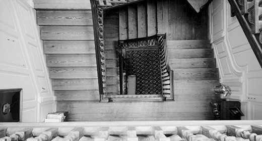 A photograph shows the view down the stairway from the third floor of Westover Plantation.